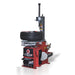 Red tyre balancing machine with a tire on it against a white background